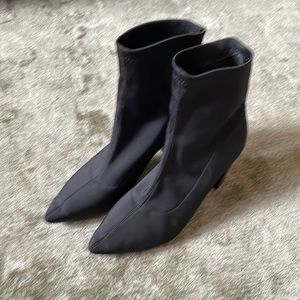 Black heeled women’s soft side boots.